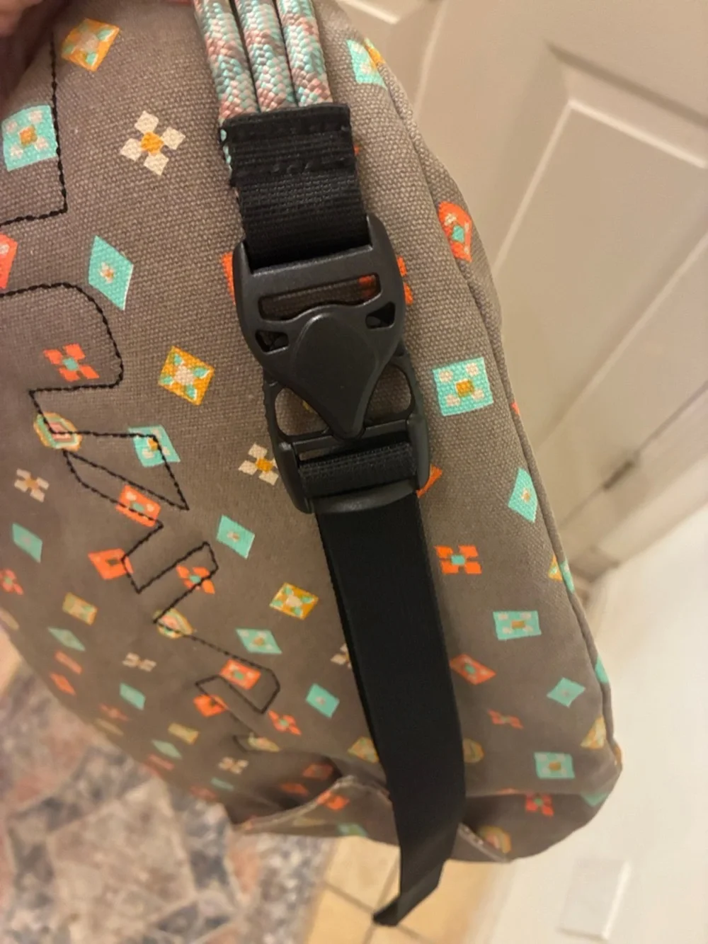 Kavu taupe sling bag with turquoise &‎ orange geometric print